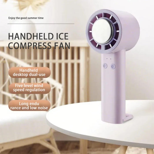 A white or pink handheld mini portable rechargeable fan with a built-in stand, blowing a cool breeze. The fan is lightweight and has a modern, minimalist design.