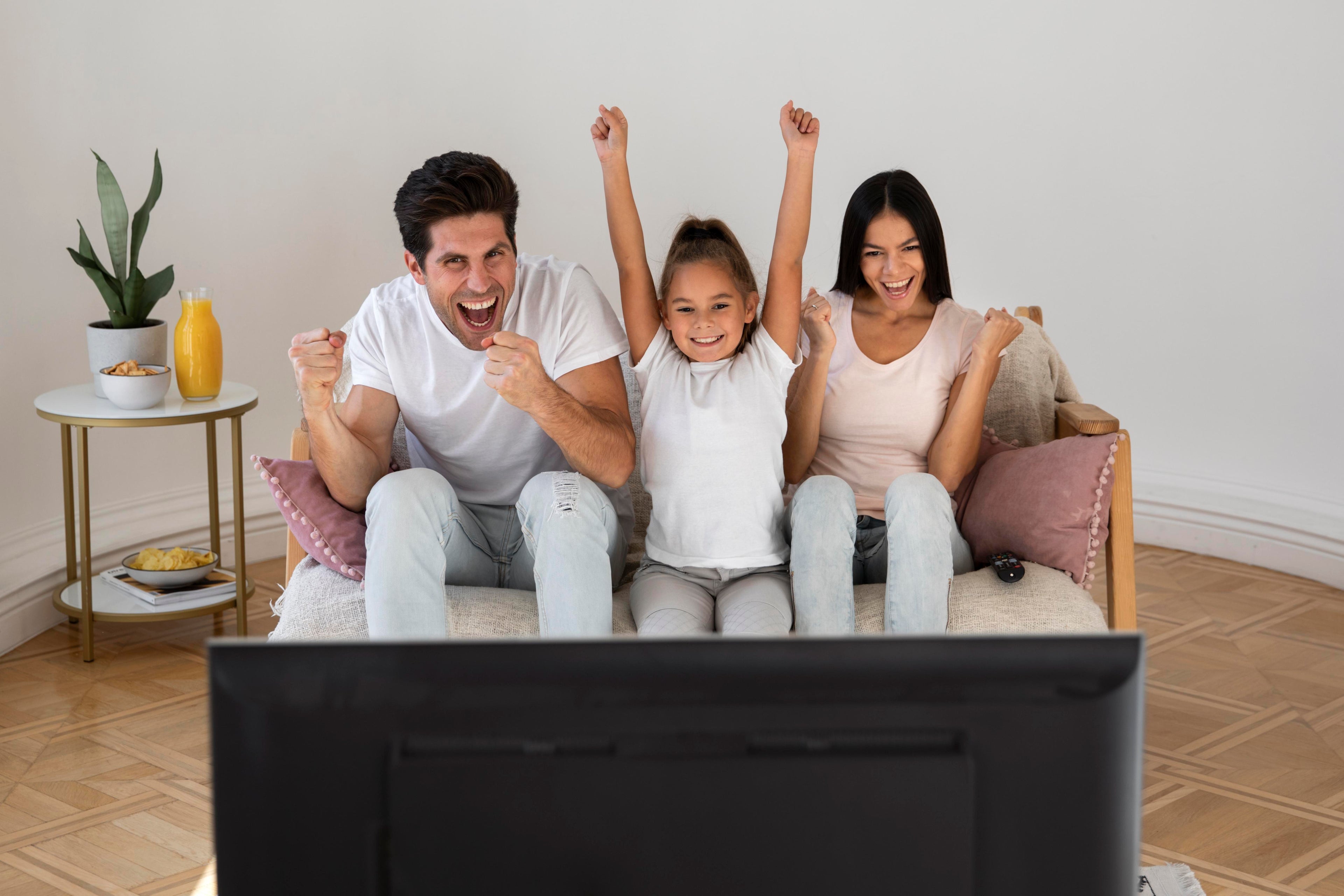 Family using high-speed internet at home – streaming on TV, browsing on phone, working on laptop, and gaming with fast Wi-Fi connection