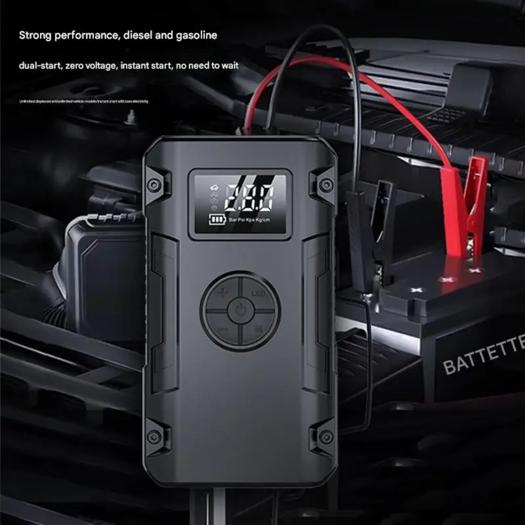Car battery jump starter with digital display on a car engine background